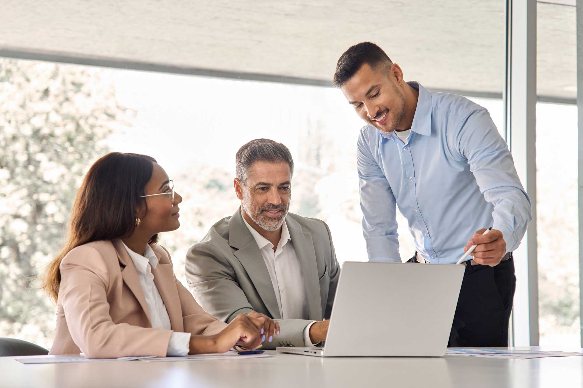 happy-business-people-executive-team-working-at-laptop-using-computer-having-discussion-at-office